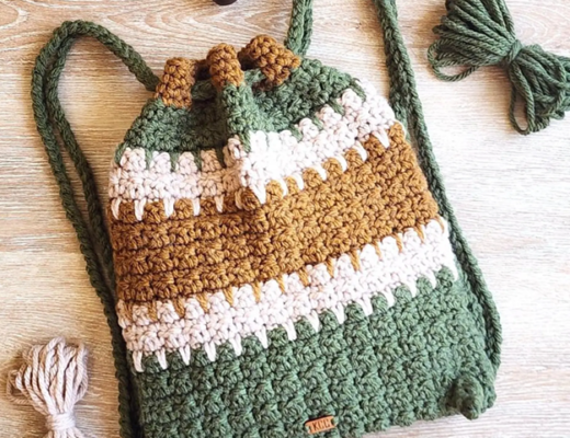 The Acorn Trail Backpack is a stylish string bag that shows off rich bands of color. The roomy bag is crocheted with size 5, bulky weight yarn, and the wide stripes are set off by eye-catching spike stitches. The chain stitch drawstrings become the shoulder straps when the bag is cinched.